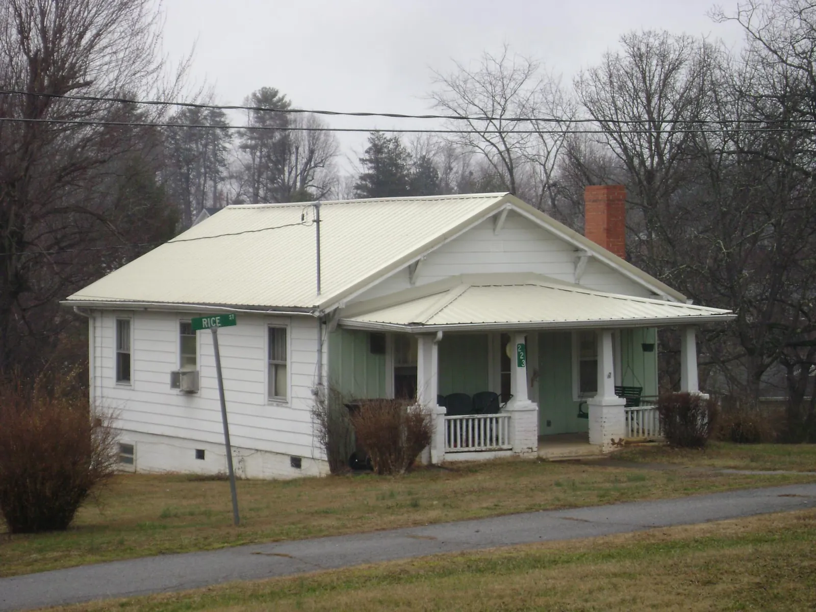 White metal roof on a craftsman bungalow at a street corner in Arlington